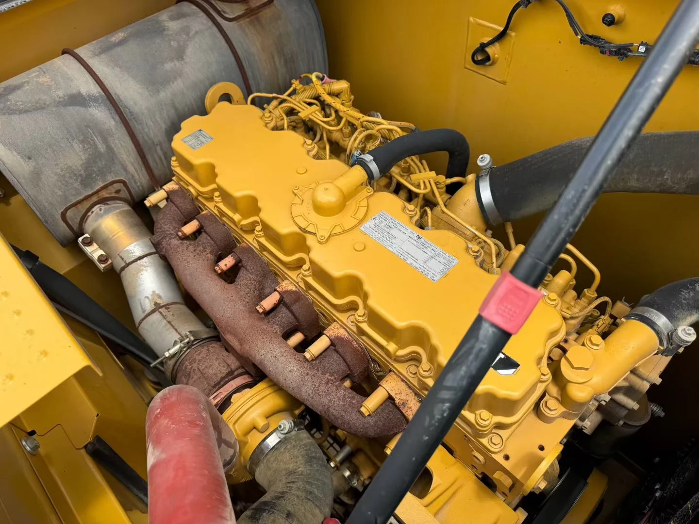 Used excavator engine bay checked against meter and maintenance records