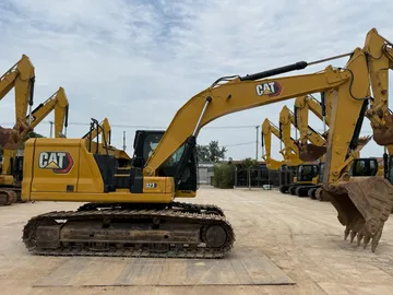 Side profile of the 2020 CAT 323 excavator in the yard.